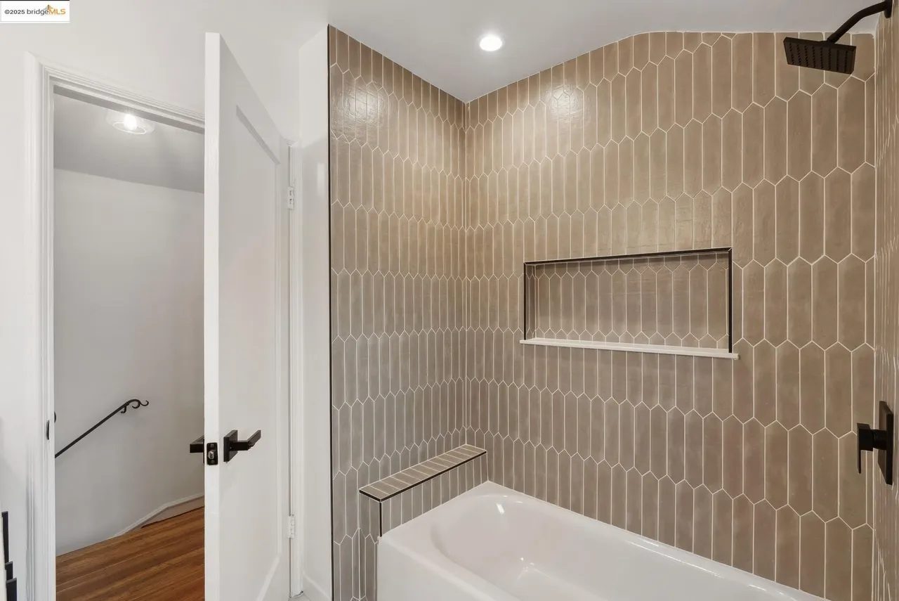 Mushroom-colored tile over a bath with niche and shower